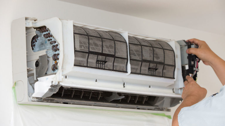 HVAC outdoor unit being maintained
