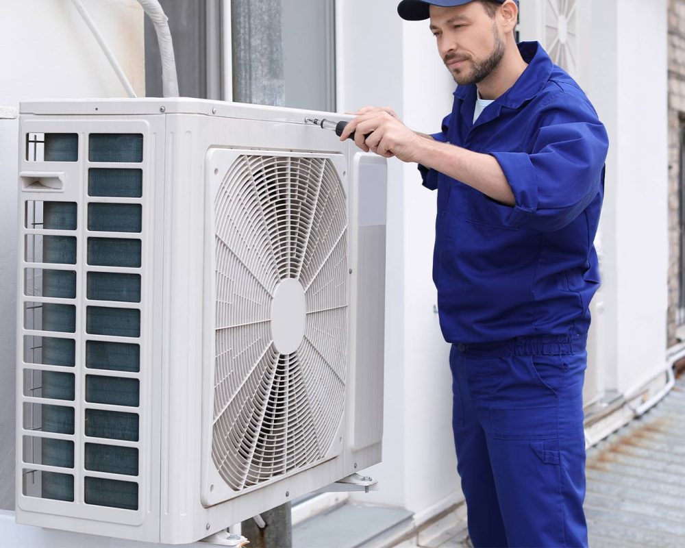 worker installing commercial ac unit